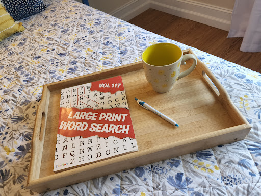 Enjoying a cozy word search session with a warm drink.