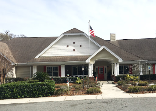 A welcoming residential building with a flag proudly displayed in the front yard.