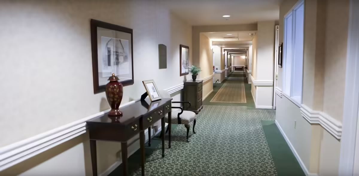 A well-lit hallway with elegant furniture and decor.