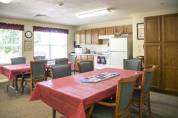 A cozy kitchen and dining area with a table, chairs, and appliances.