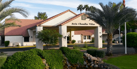 Entrance to a villa with well-maintained landscaping.