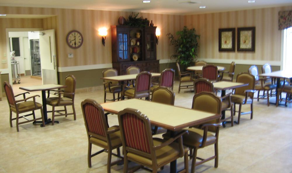 An empty dining room with tables and chairs arranged neatly.