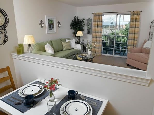 A modern apartment living room with a cozy dining area and tasteful decor.