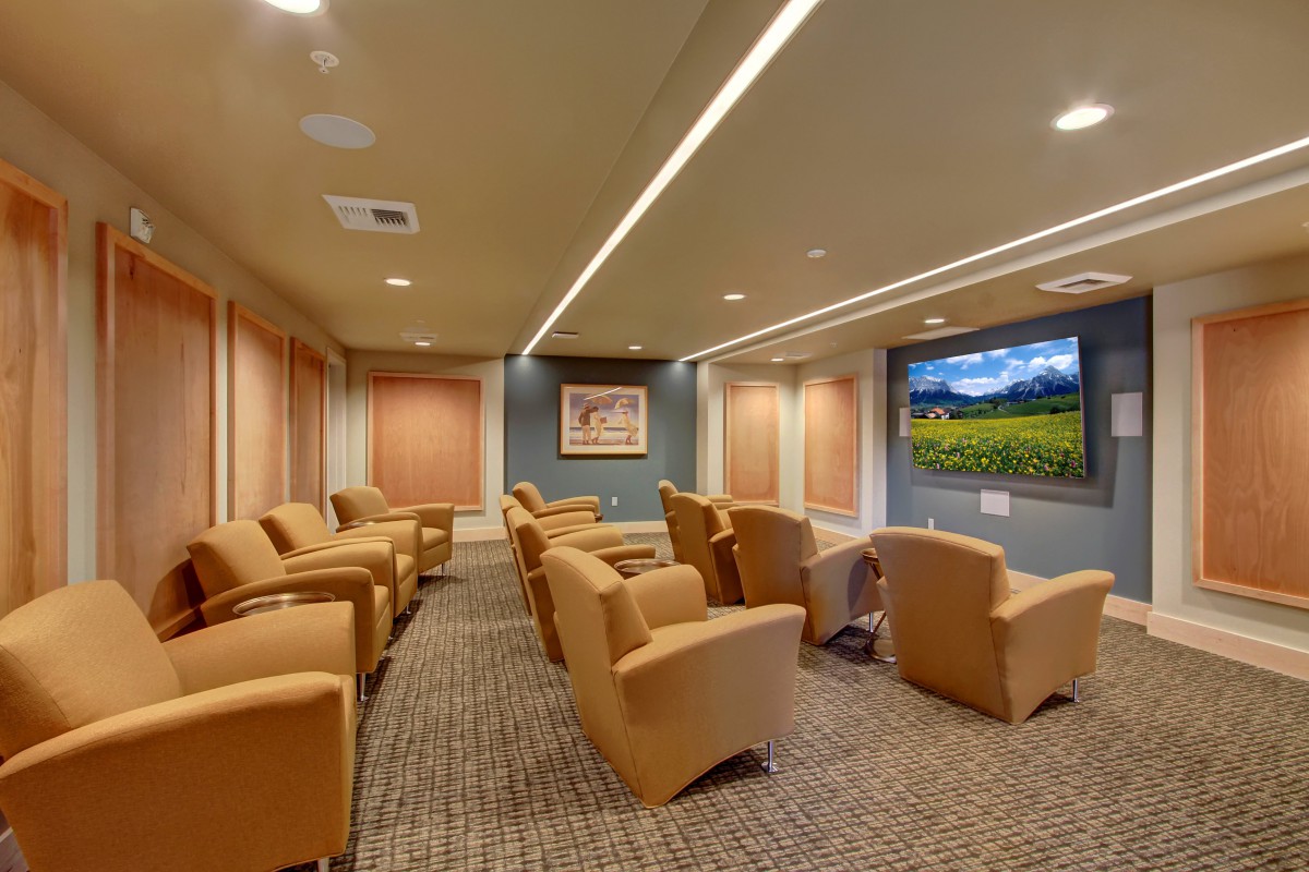 A cozy theater room with comfortable seating and a large screen.