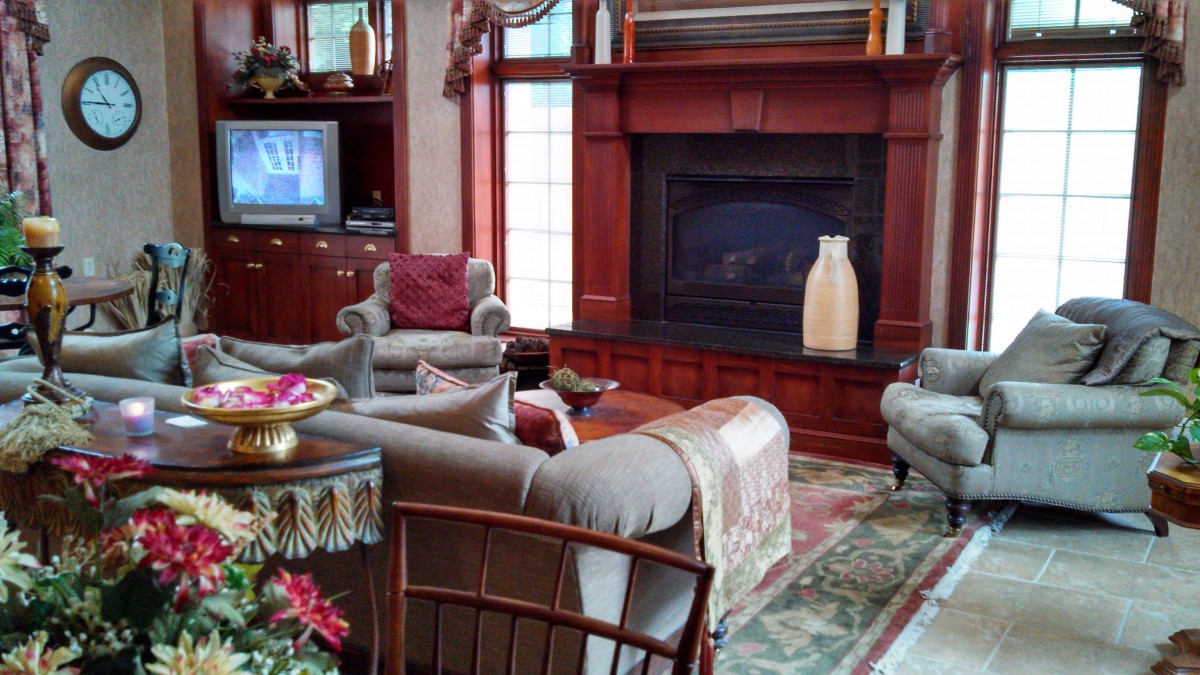 A cozy living room with elegant furnishings and a fireplace.