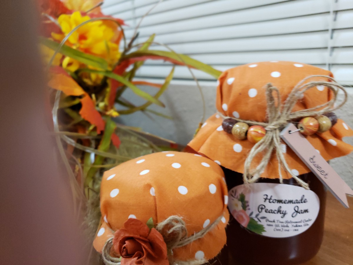 Decorative homemade goods in polka dot covers alongside autumn flowers.