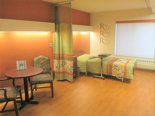 A well-designed hospital room featuring comfortable seating and a cozy atmosphere.