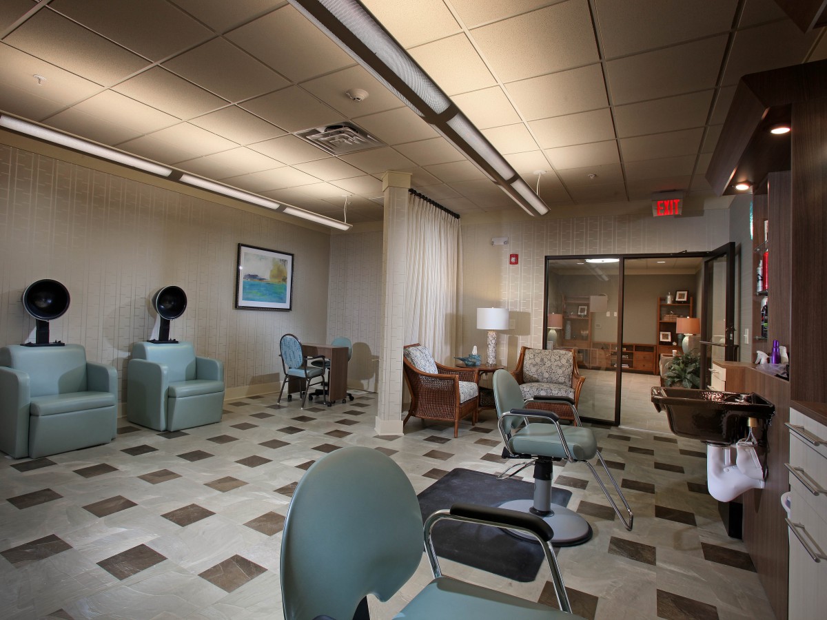 An empty waiting room with chairs and subdued lighting.