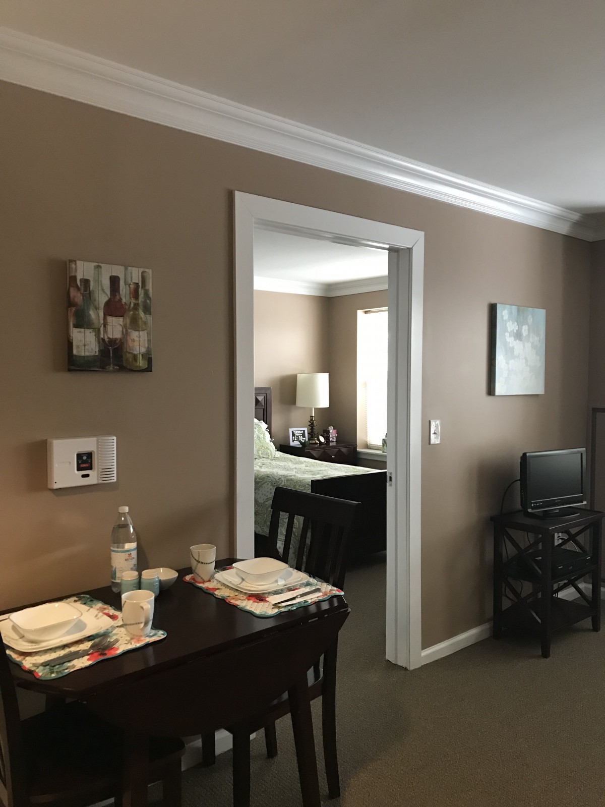 View of a cozy apartment interior featuring a dining area and bedroom.