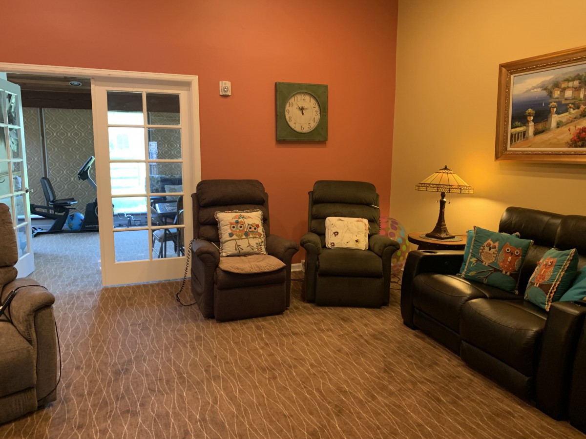 Cozy living room with recliners, sofa, and decorative elements.