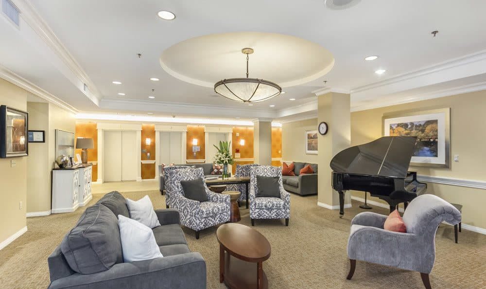 A luxurious lobby with comfortable seating, elegant lighting, and a grand piano.