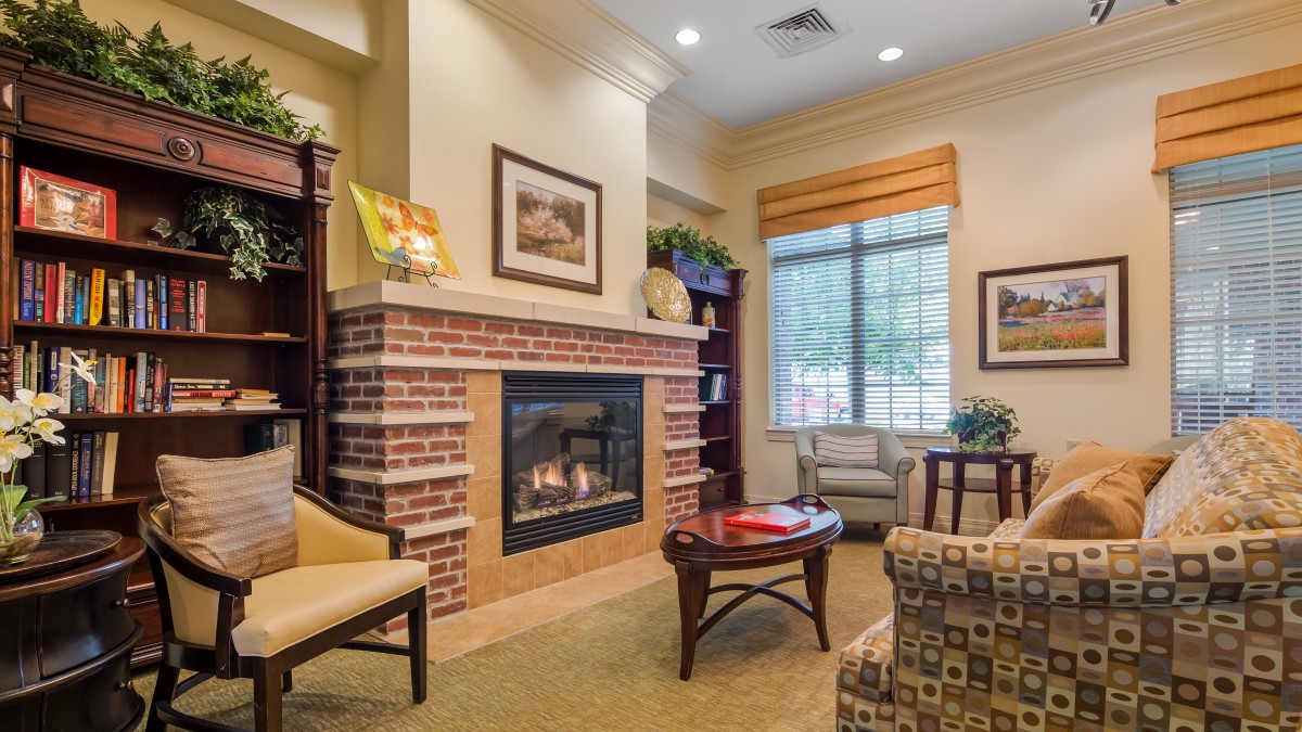 A cozy living room with a fireplace, comfortable seating, and elegant decor.