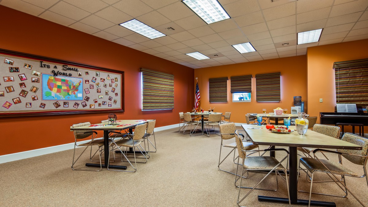 A spacious classroom with tables and chairs arranged for group learning.