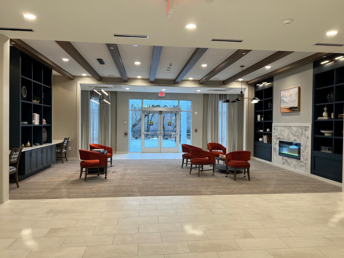 A modern lobby with comfortable seating and a fireplace.