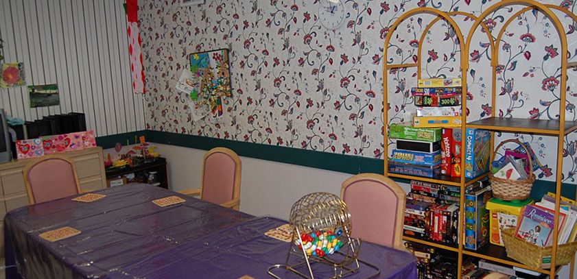 A cozy game room featuring a bingo set and board games on a shelf.
