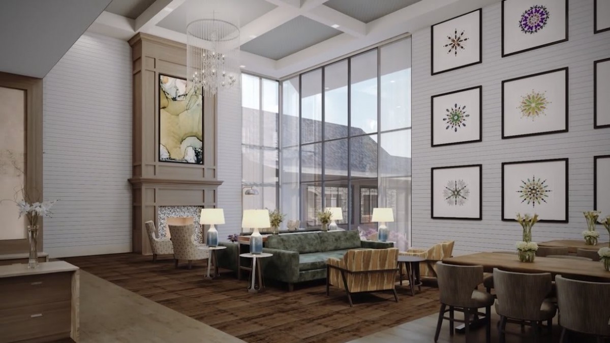 A modern lobby with a high ceiling, large windows, and elegant seating area.