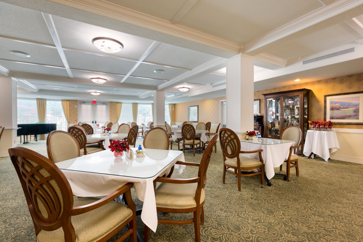 An elegant dining room with neatly arranged tables and chairs.