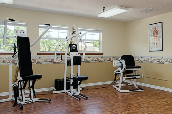 A small gym with exercise machines for workouts.
