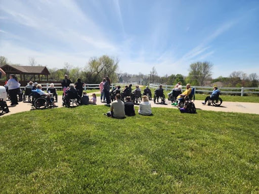 A gathering of people enjoying a sunny day outdoors.