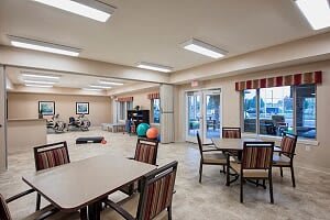 A community room featuring exercise equipment and seating areas.