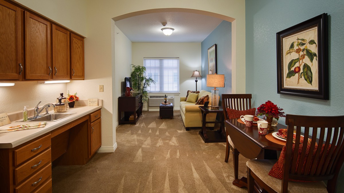 Cozy living and dining area with a sofa, dining table, and television.