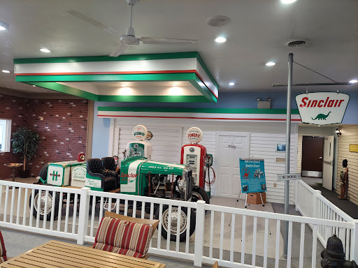 A nostalgic gas station-themed diner interior with vintage decor and pump figurines.