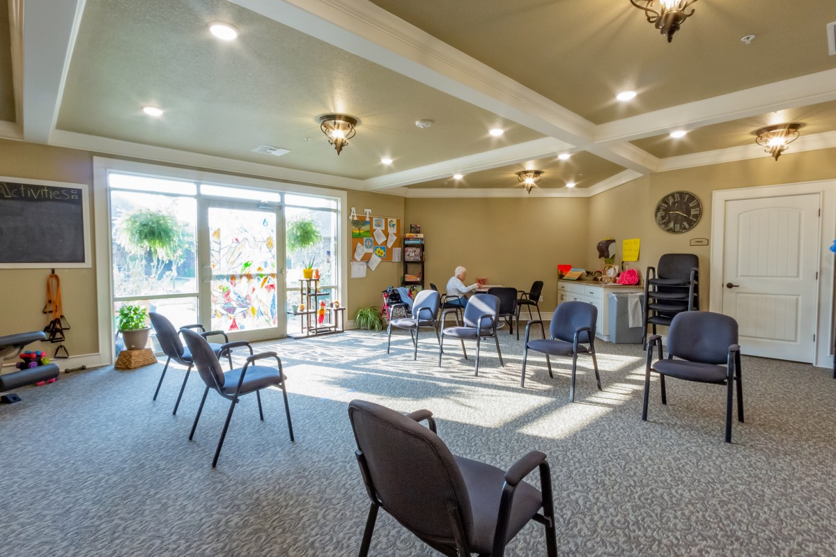 A bright and spacious waiting room with multiple chairs and large windows.