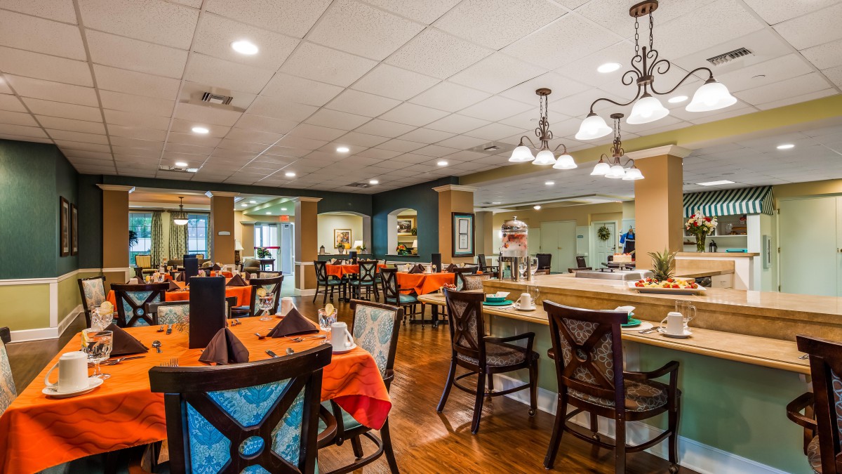 A cozy restaurant dining area with tables and chairs set for service.