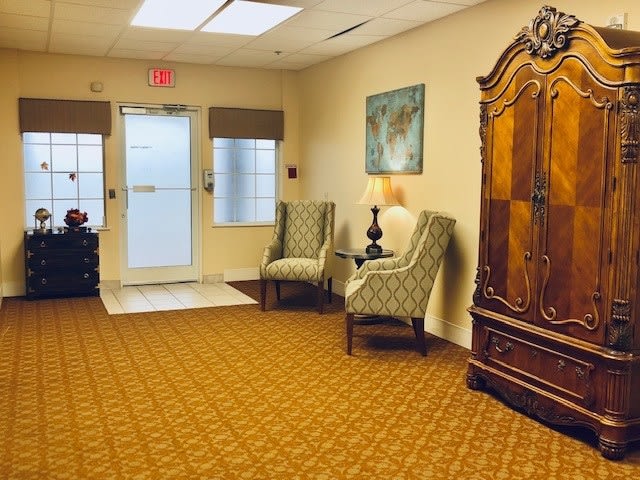 A cozy waiting room with elegant furniture and warm decor.