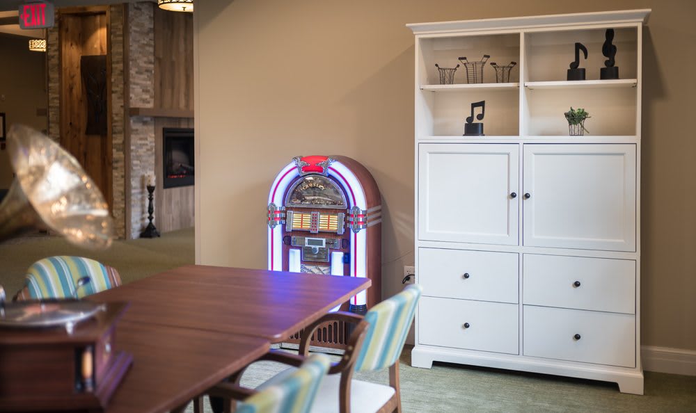 A retro jukebox adds a vintage touch to a cozy dining room setting.