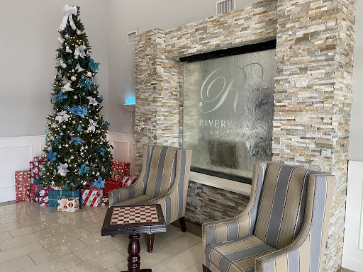 A festive lobby adorned with a beautifully decorated Christmas tree and comfortable seating.