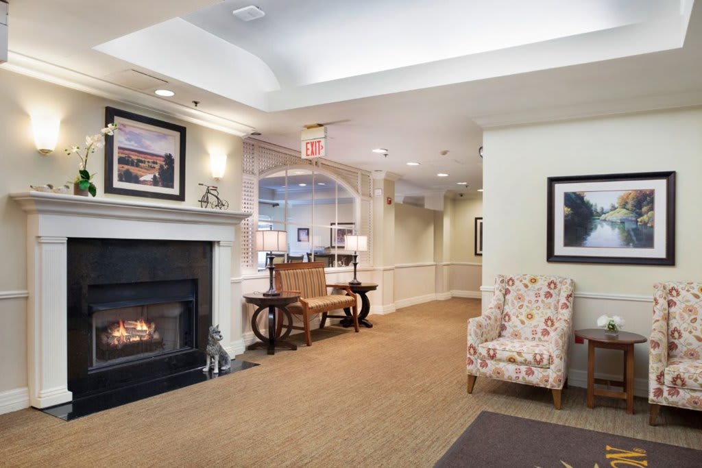 A cozy lobby interior with a fireplace and comfortable seating.