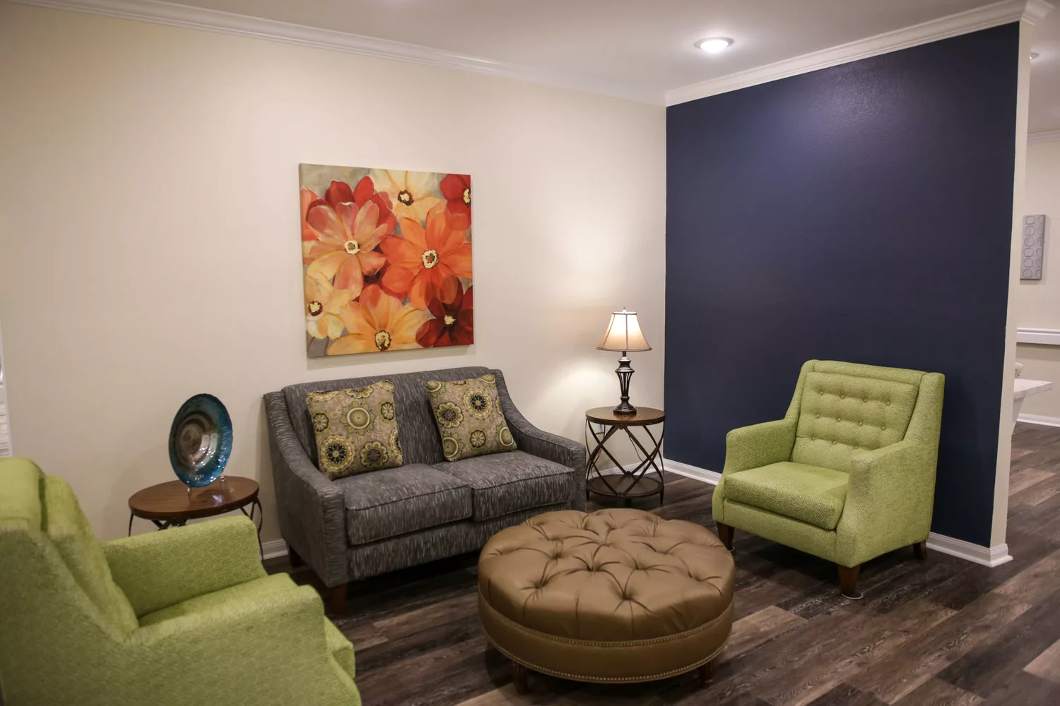 A cozy living room with modern furniture and colorful artwork.
