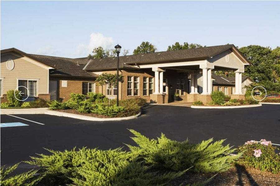 A well-landscaped entrance to a residential building during the daytime.