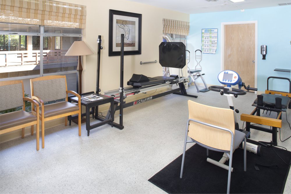 A fitness room equipped with a treadmill and stationary bike.
