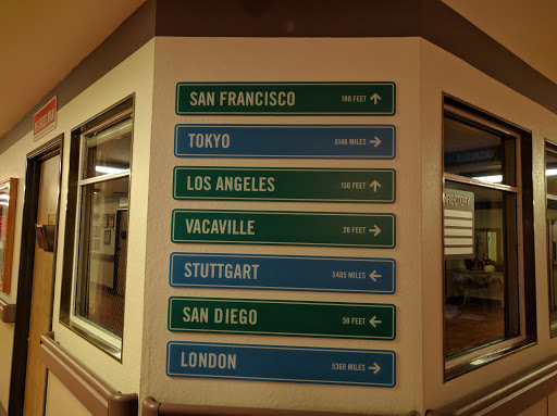 Sign displaying various city names, possibly indicating distance or directions.