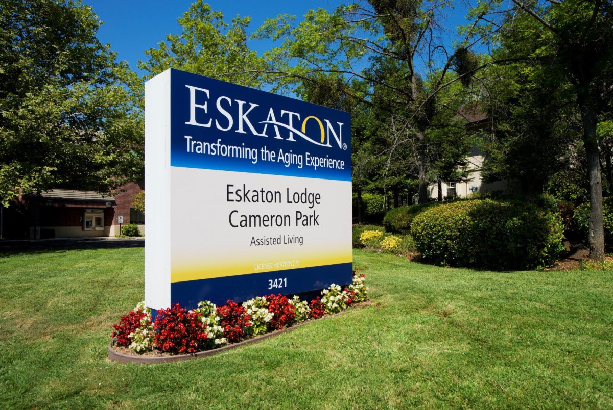 Sign for Eskaton Lodge Cameron Park surrounded by well-maintained landscaping.