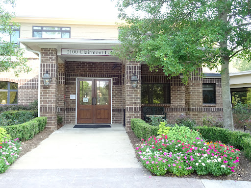 A welcoming entrance with well-maintained landscaping and colorful flowers.