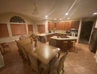 Spacious kitchen and dining area with a large table and island counter.