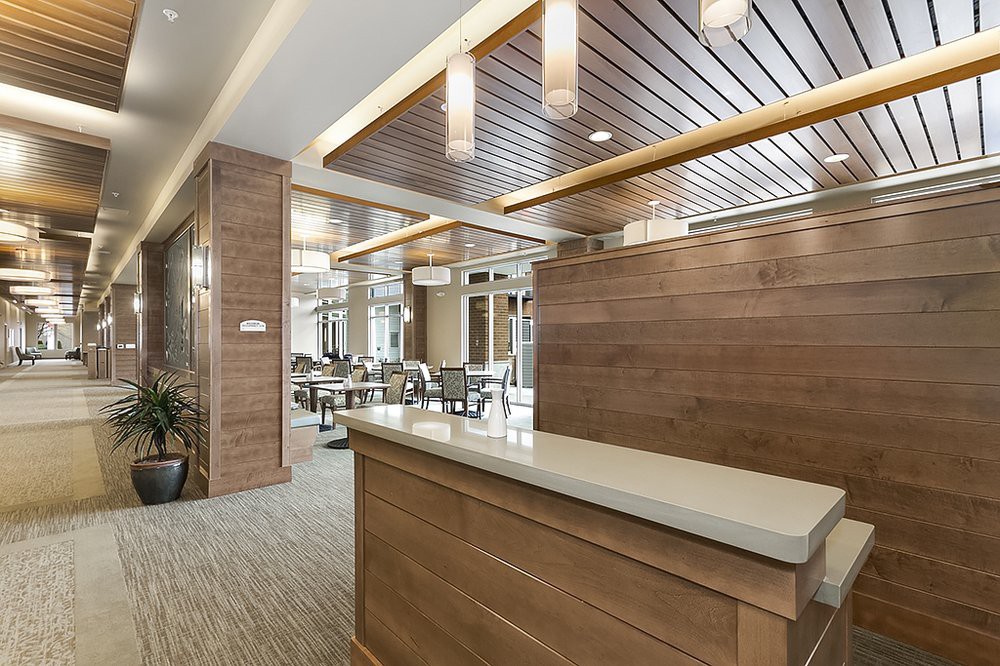 A modern reception area featuring wood paneling and elegant lighting.