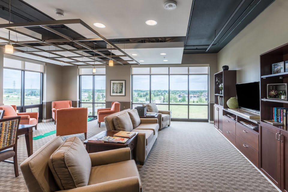 A modern lounge area with comfortable seating and large windows providing a scenic view.