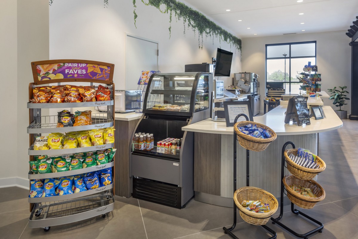 Interior of a convenience store with snack displays and a service counter.