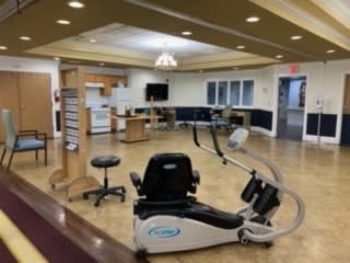 A fitness area with gym equipment for rehabilitation and exercise.