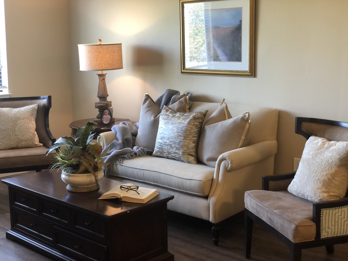 A cozy living room with a comfortable sofa, armchair, and decorative elements.