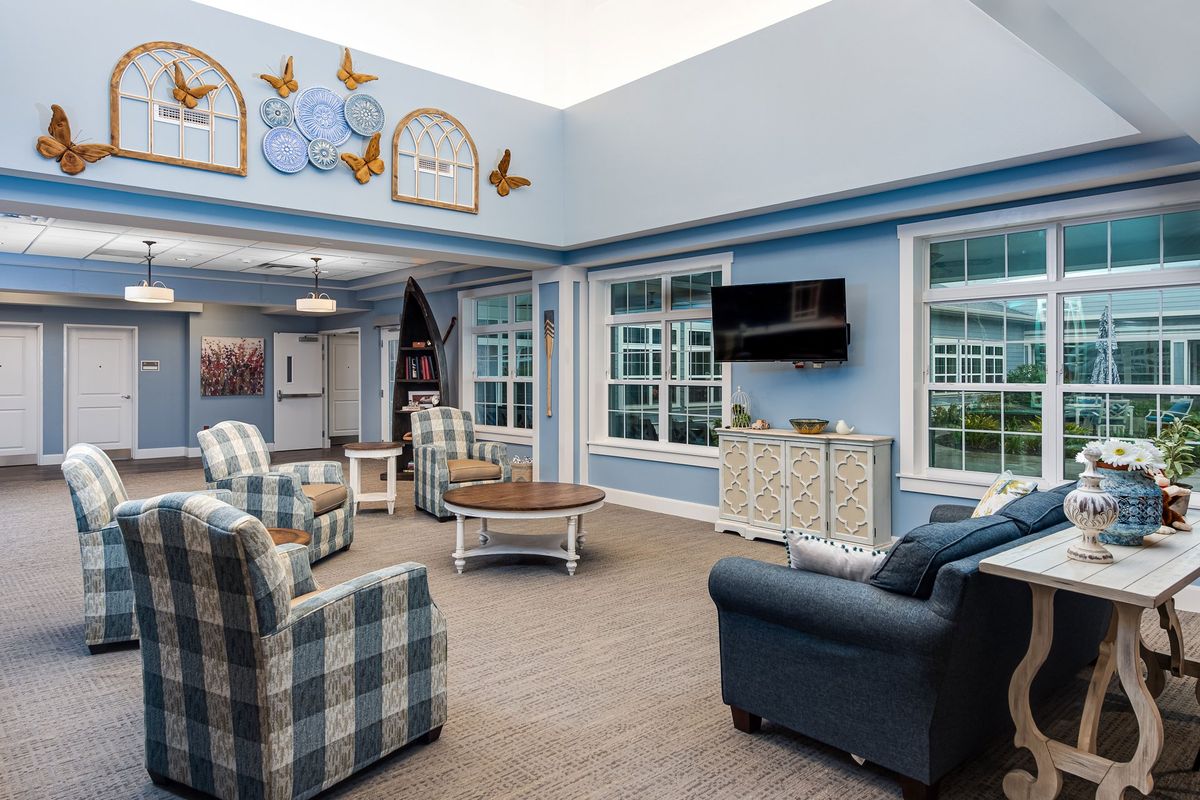 A cozy living room with comfortable seating and large windows.