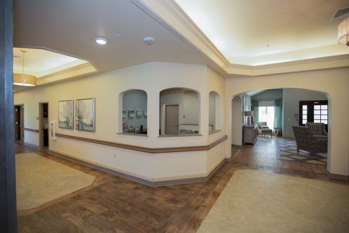 A modern lobby hallway with artwork on the walls and stylish lighting.