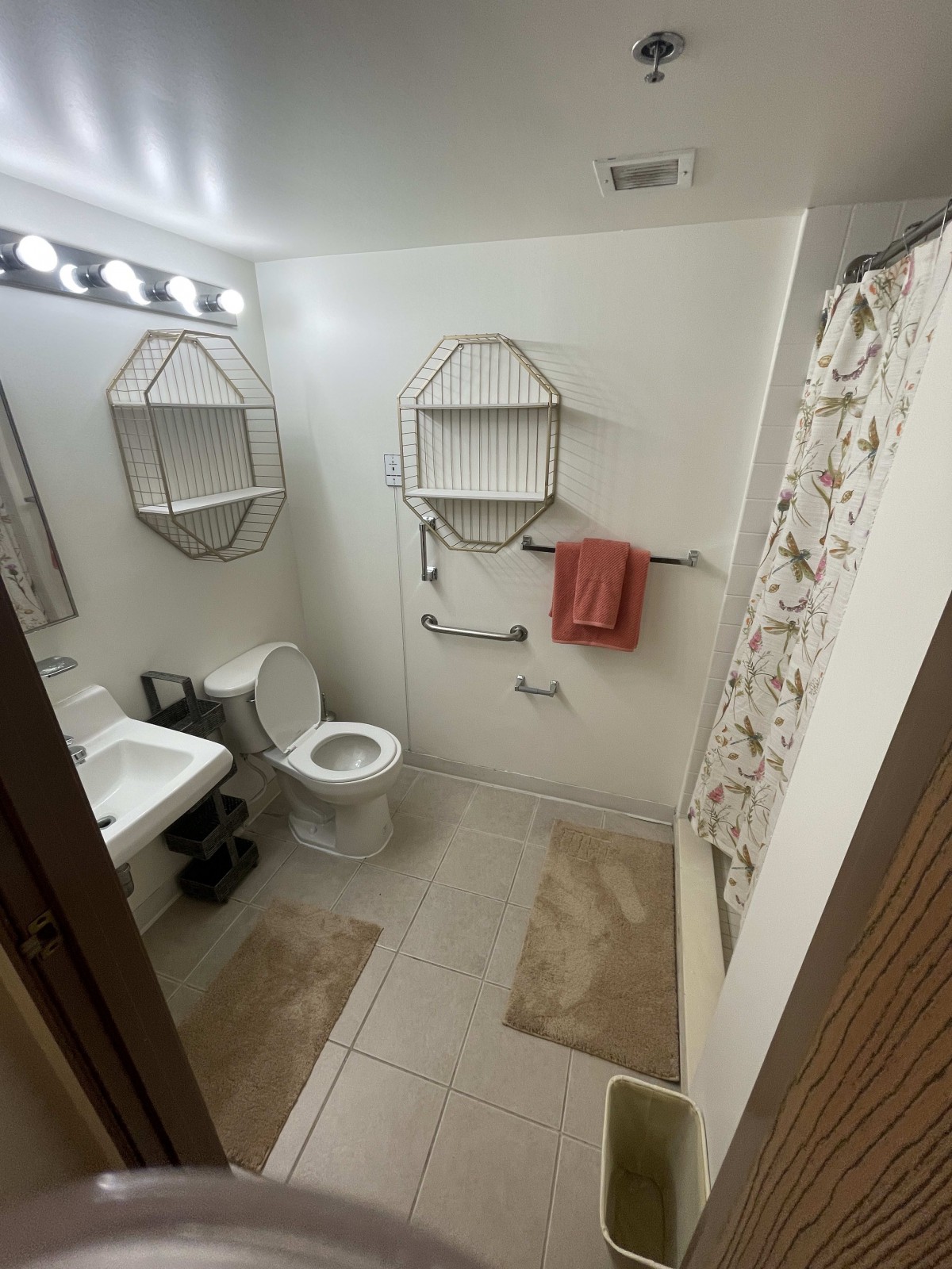 A clean and organized bathroom with essential fixtures and decor.