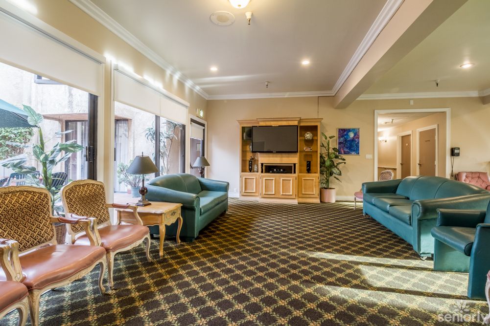 A cozy living room with sofas, a television, and elegant decor.