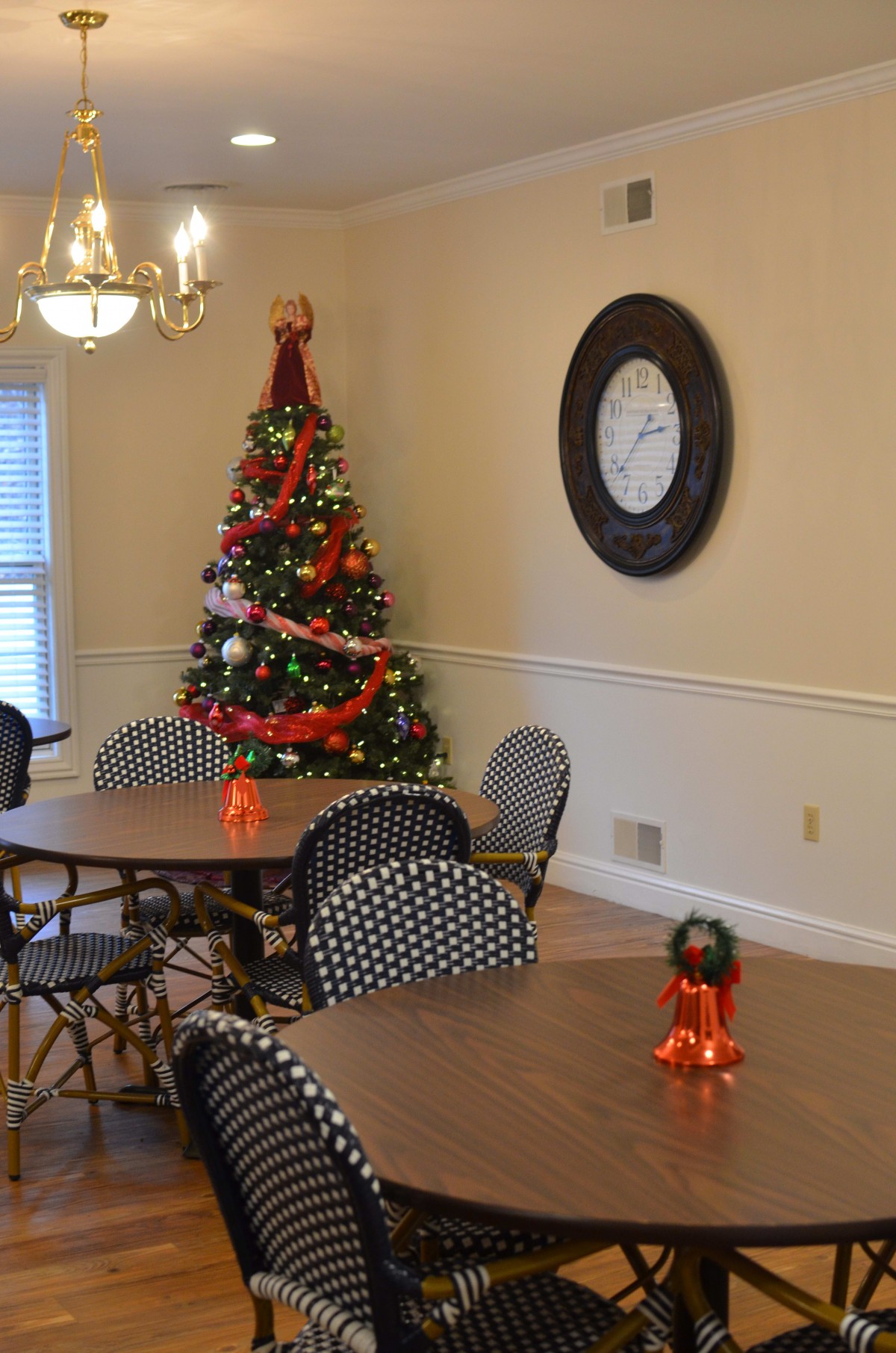 A cozy dining area decorated for Christmas with a festive tree and holiday ornaments.