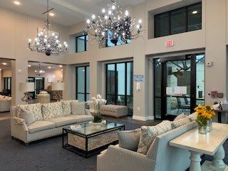 Elegant lobby with modern seating and chandeliers.